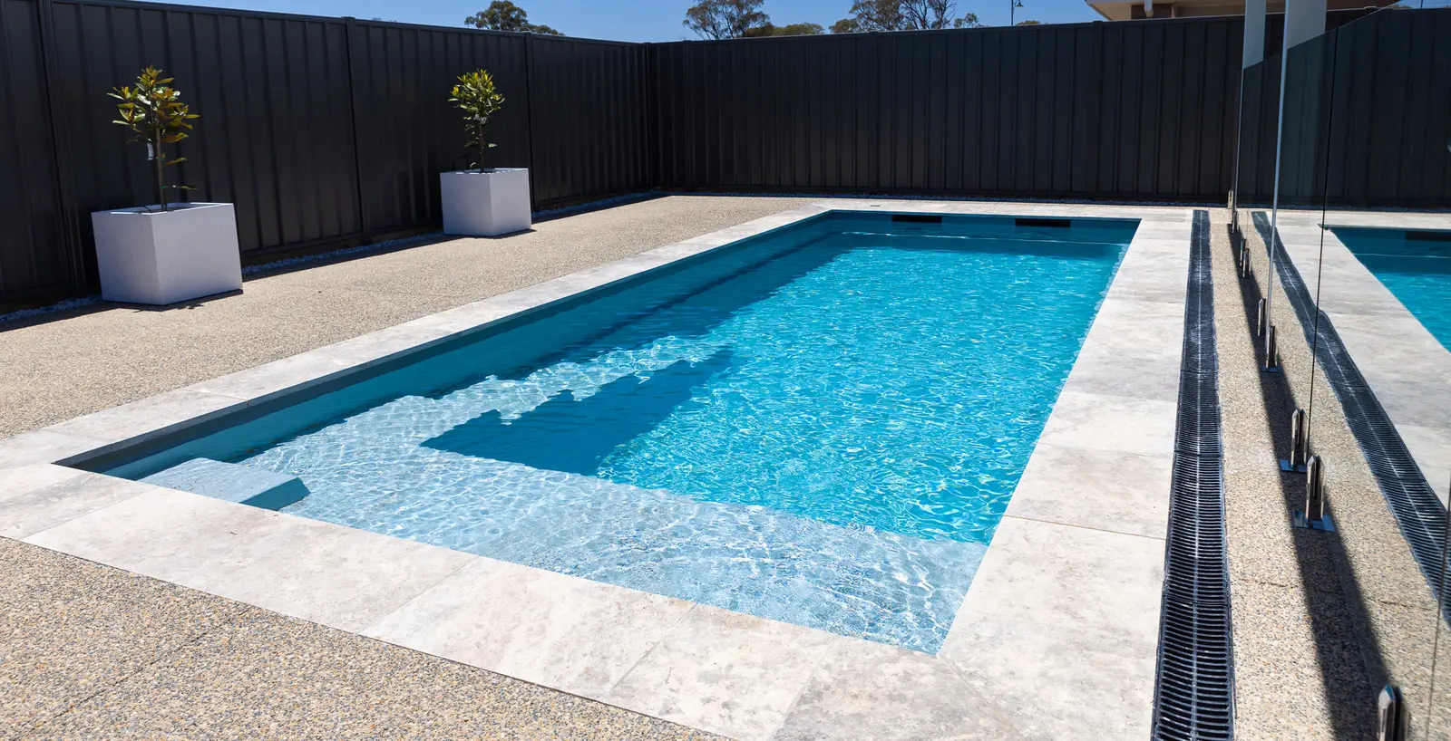 A finished GV Unique pool with a concrete surround